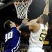 Michigan sophomore Jordan Morgan takes a shot over Northwestern senior Davide Curletti in the second quarter against Northwestern at Crisler Center on Wedensday. Melanie Maxwell I AnnArbor.com